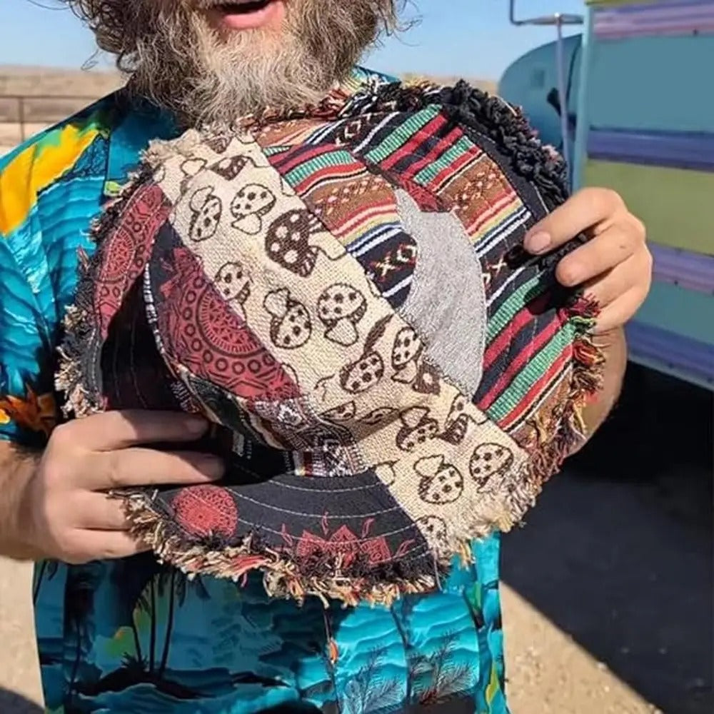 Person holding a colorful patchwork bag with a patterned shirt
